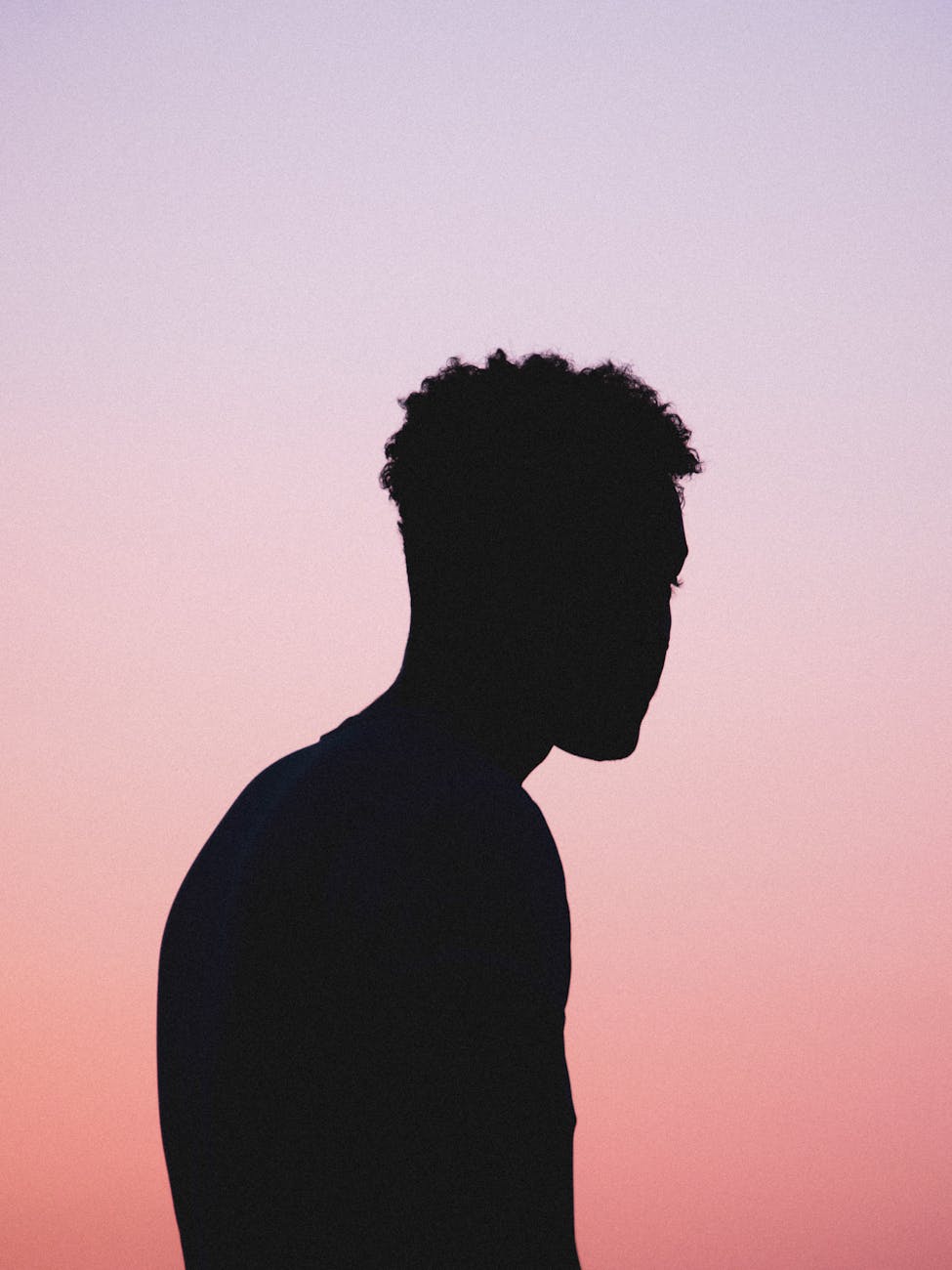 A calm silhouette of a man stretching against a linen-colored background.